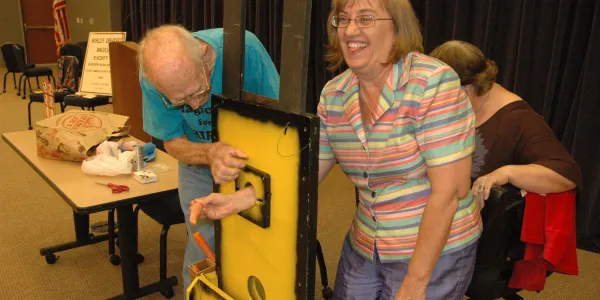 Club members preparing a stage illusion together